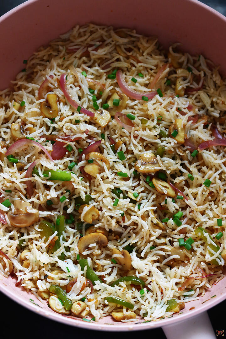 mushroom fried rice cooked in a wok