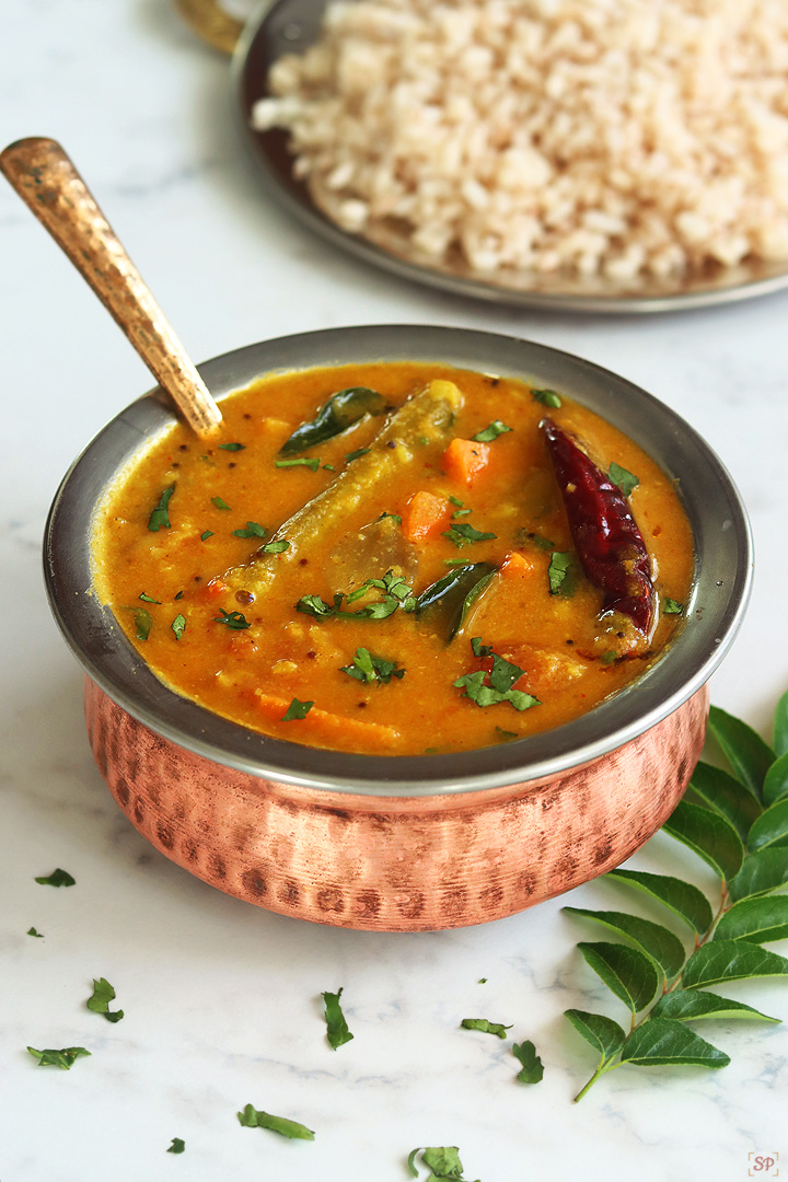 varutharacha sambar in a copper bowl