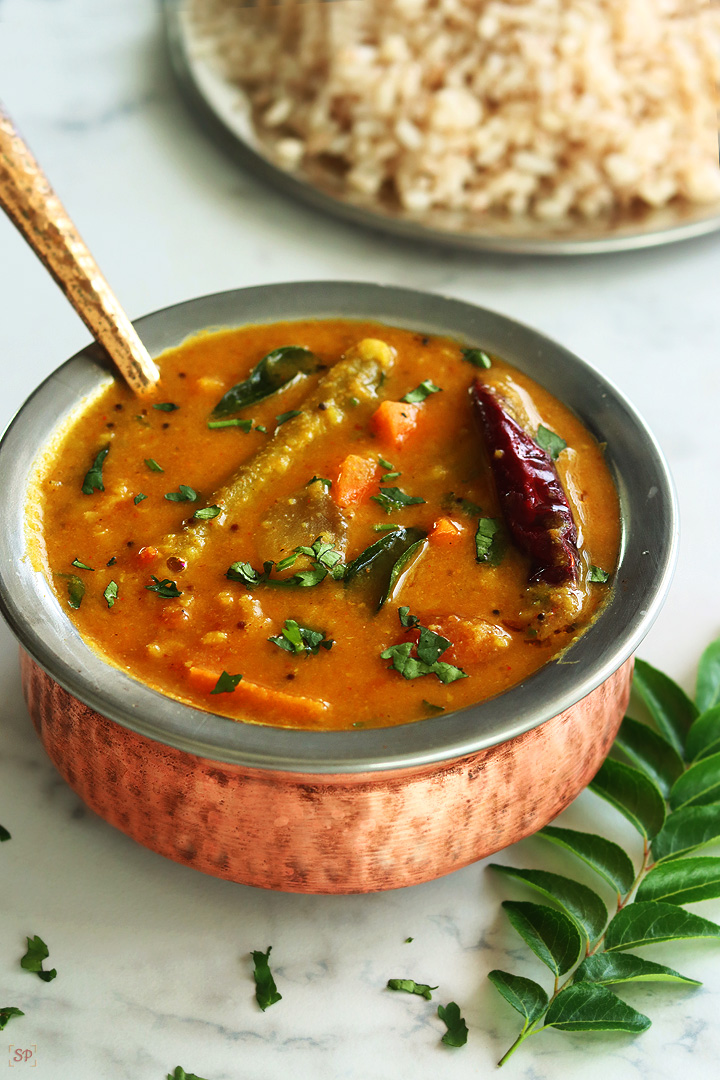 varutharacha sambar in a copper bowl