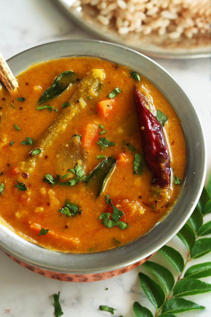 varutharacha sambar in a copper bowl