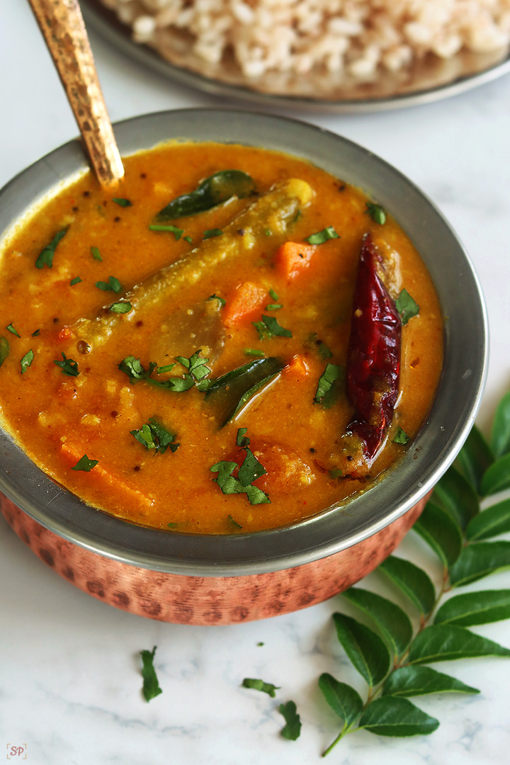 varutharacha sambar in a copper bowl