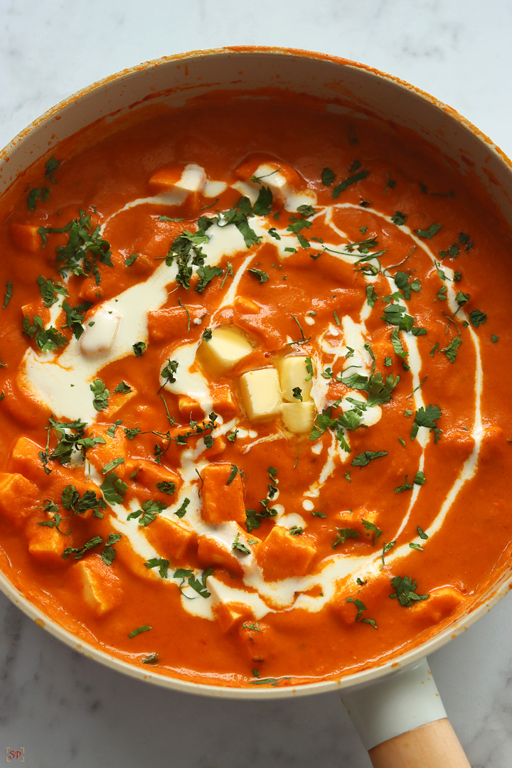 paneer butter masala in a beige color pan