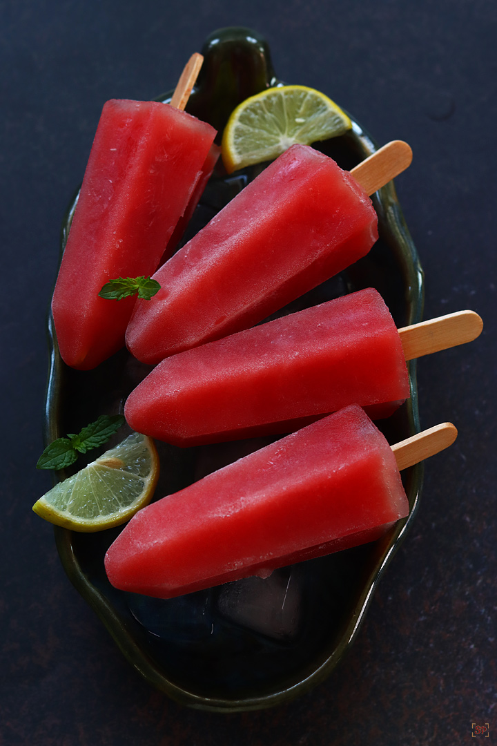 watermelon popsicles served in a plate with ice cubes
