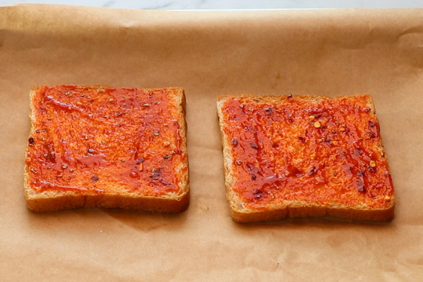 spread pizza sauce on bread