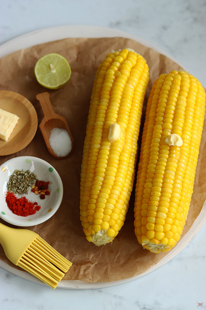 corn on the cob with seasonings on the side