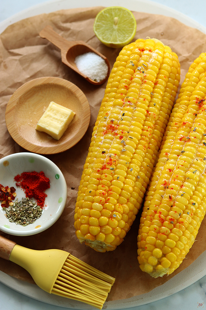 corn on the cob with seasonings on the side