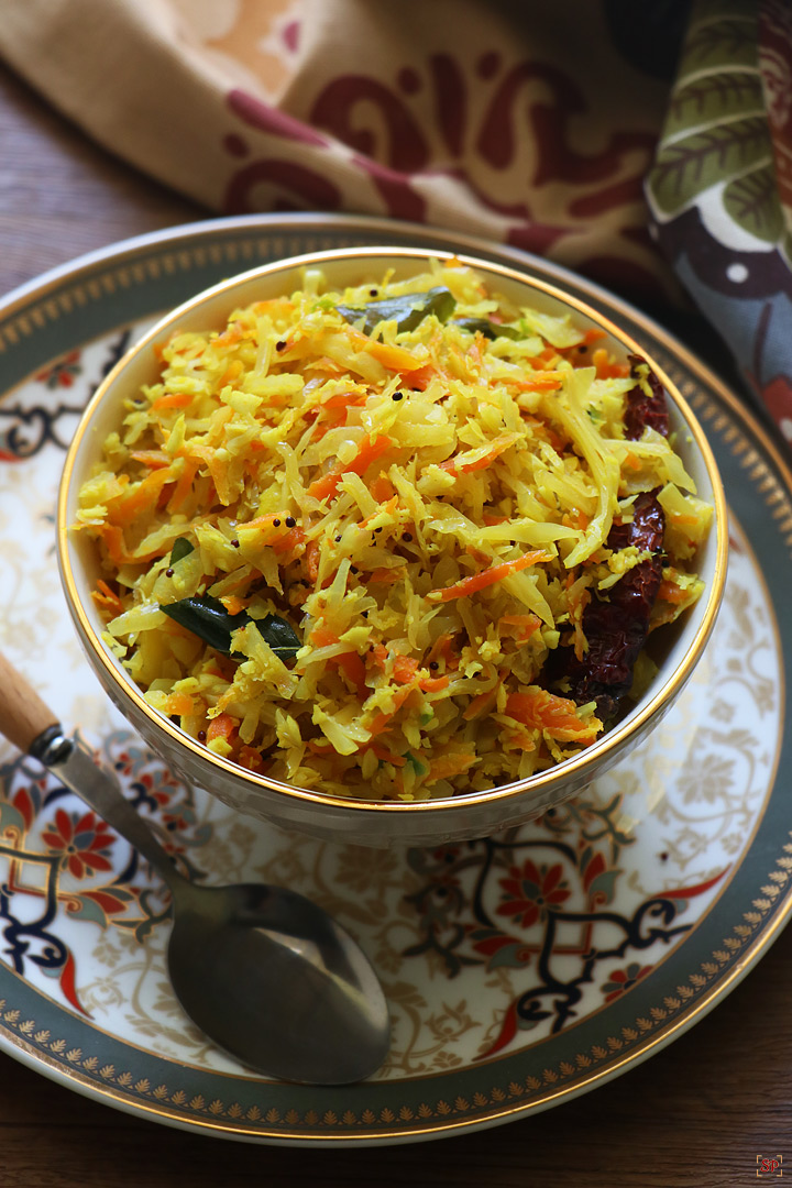 cabbage thoran with carrot in a beige color bowl