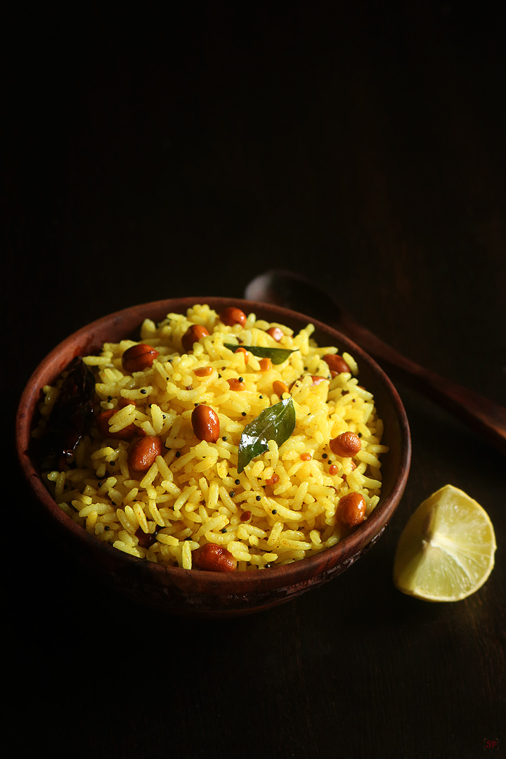 lemon rice served in a wooden bowl