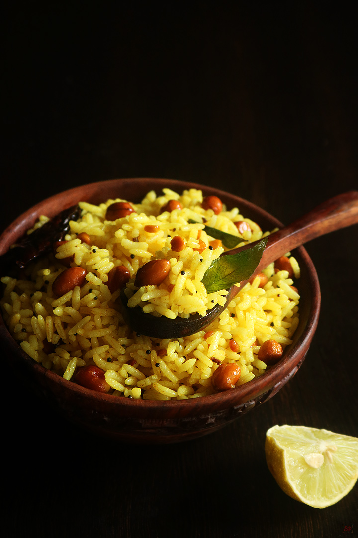 lemon rice served in a wooden bowl