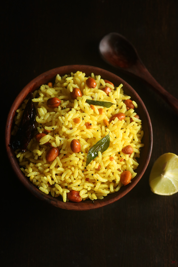 lemon rice served in a wooden bowl