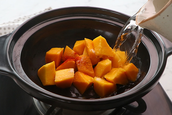 add mangoes with salt, spice powders and water