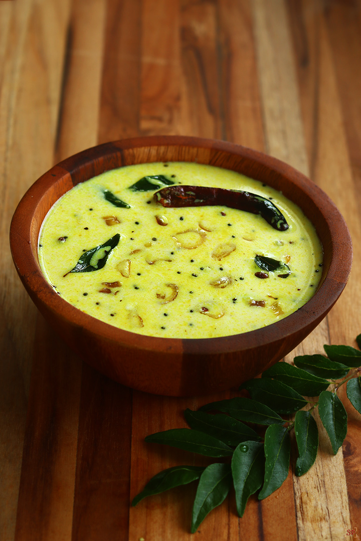 moru curry served in a wooden bowl