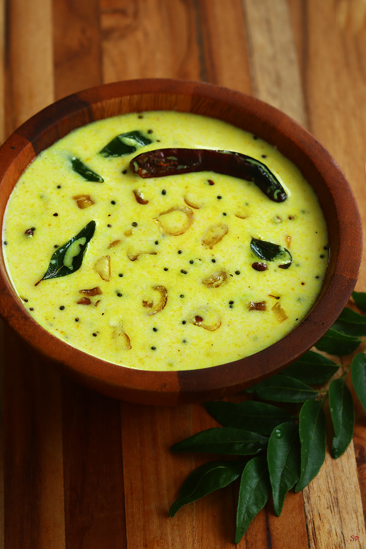 moru curry served in a wooden bowl