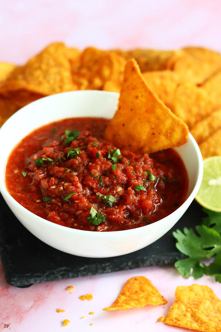 salsa served in a white bowl with tortilla chips