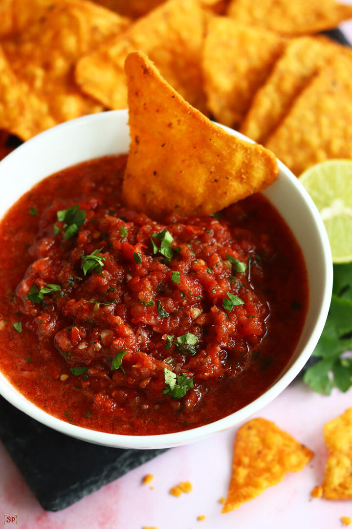 salsa served in a white bowl with tortilla chips