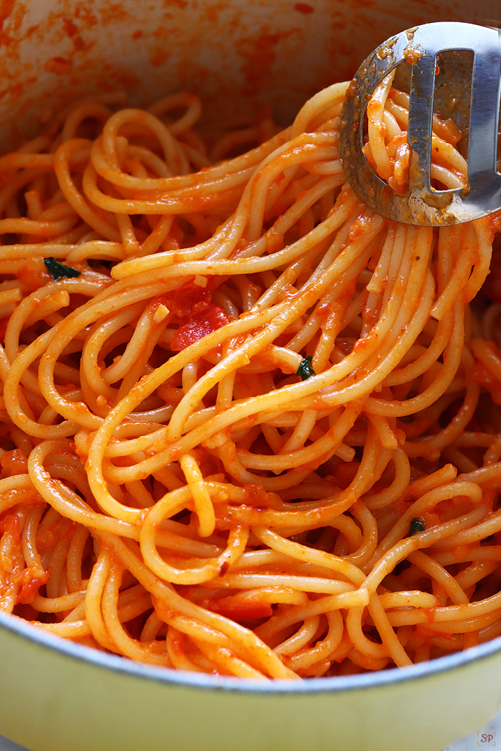 pasta pomodoro tossed using a tong