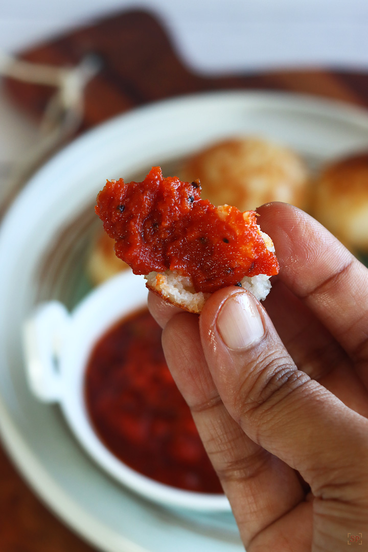 paniyaram dipped in onion tomato chutney