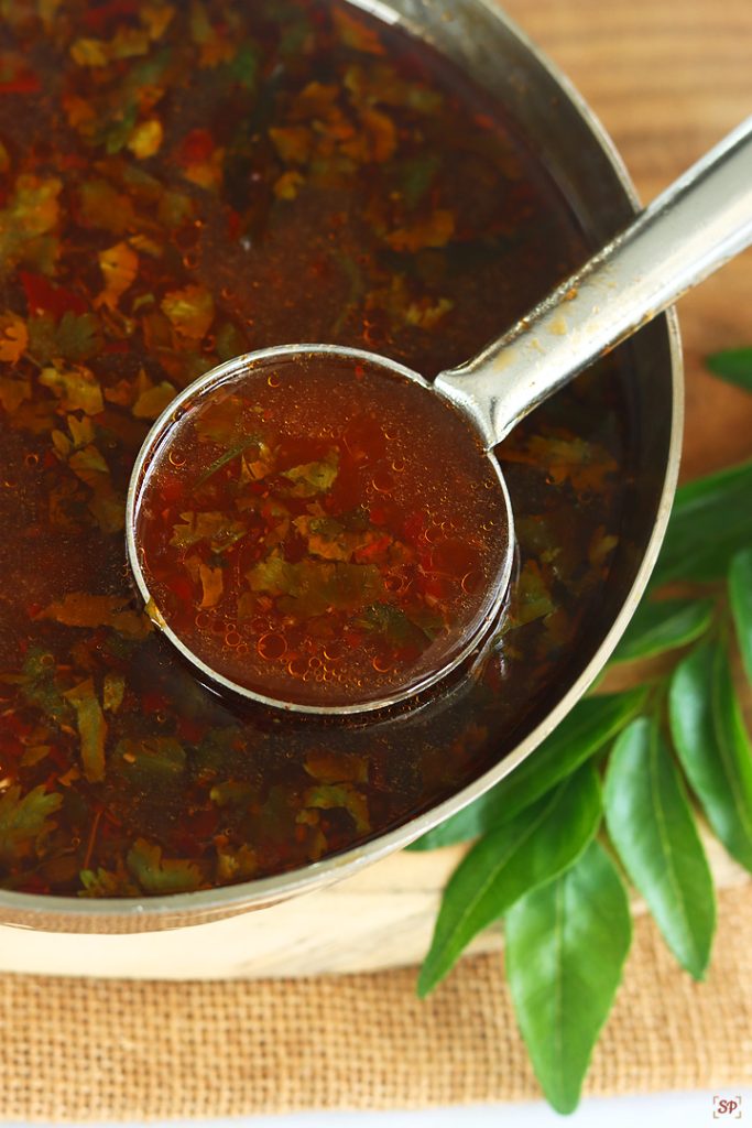 rasam in a ladle