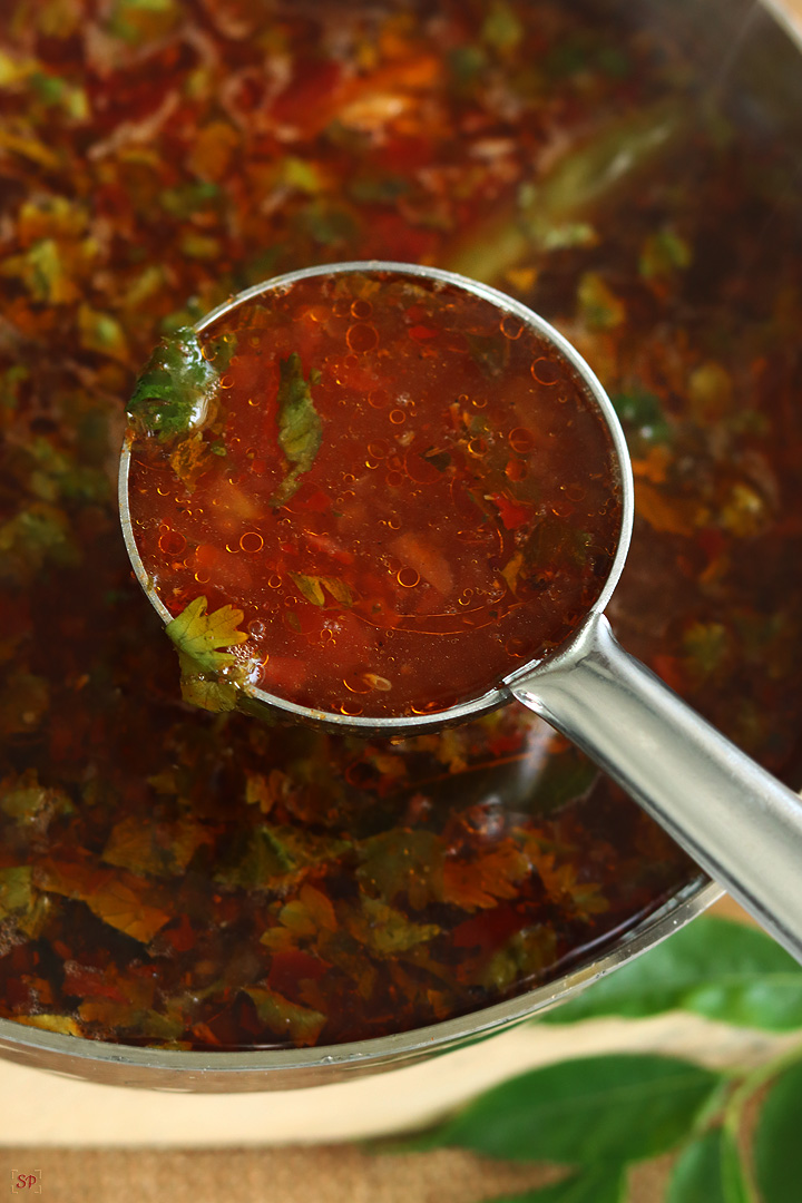 rasam in a ladle