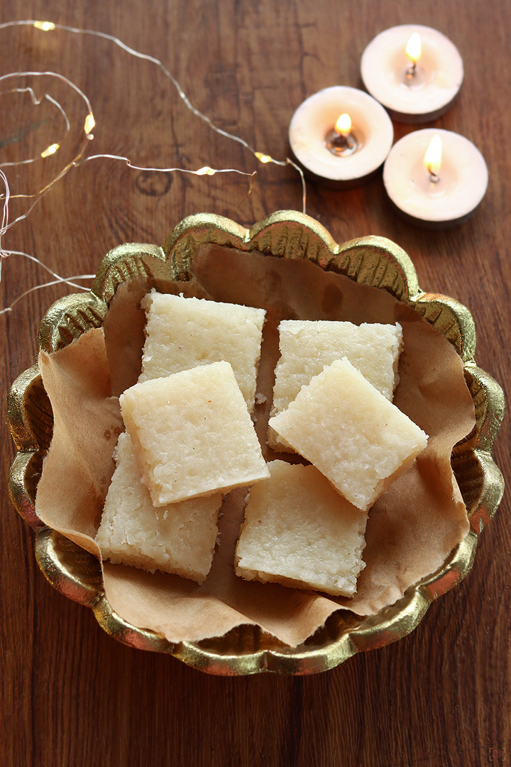 coconut burfi in a gold color plate